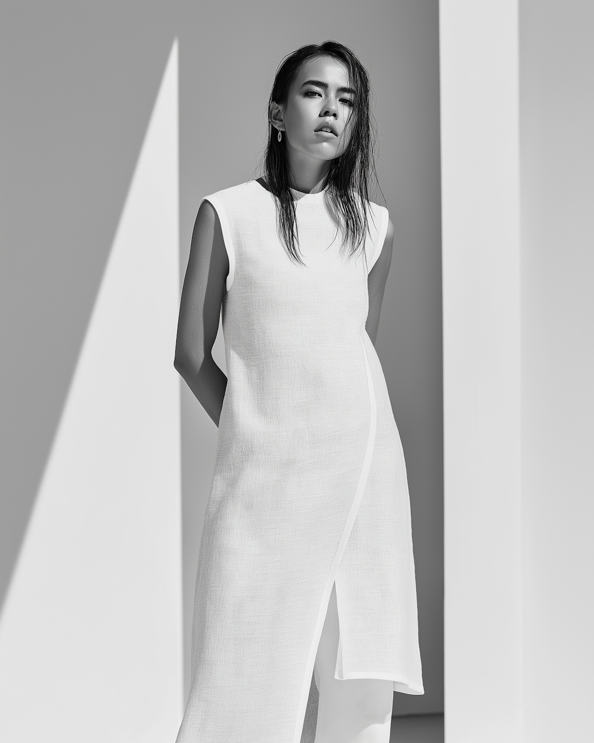 Black and white portrait cut by architectural shadows