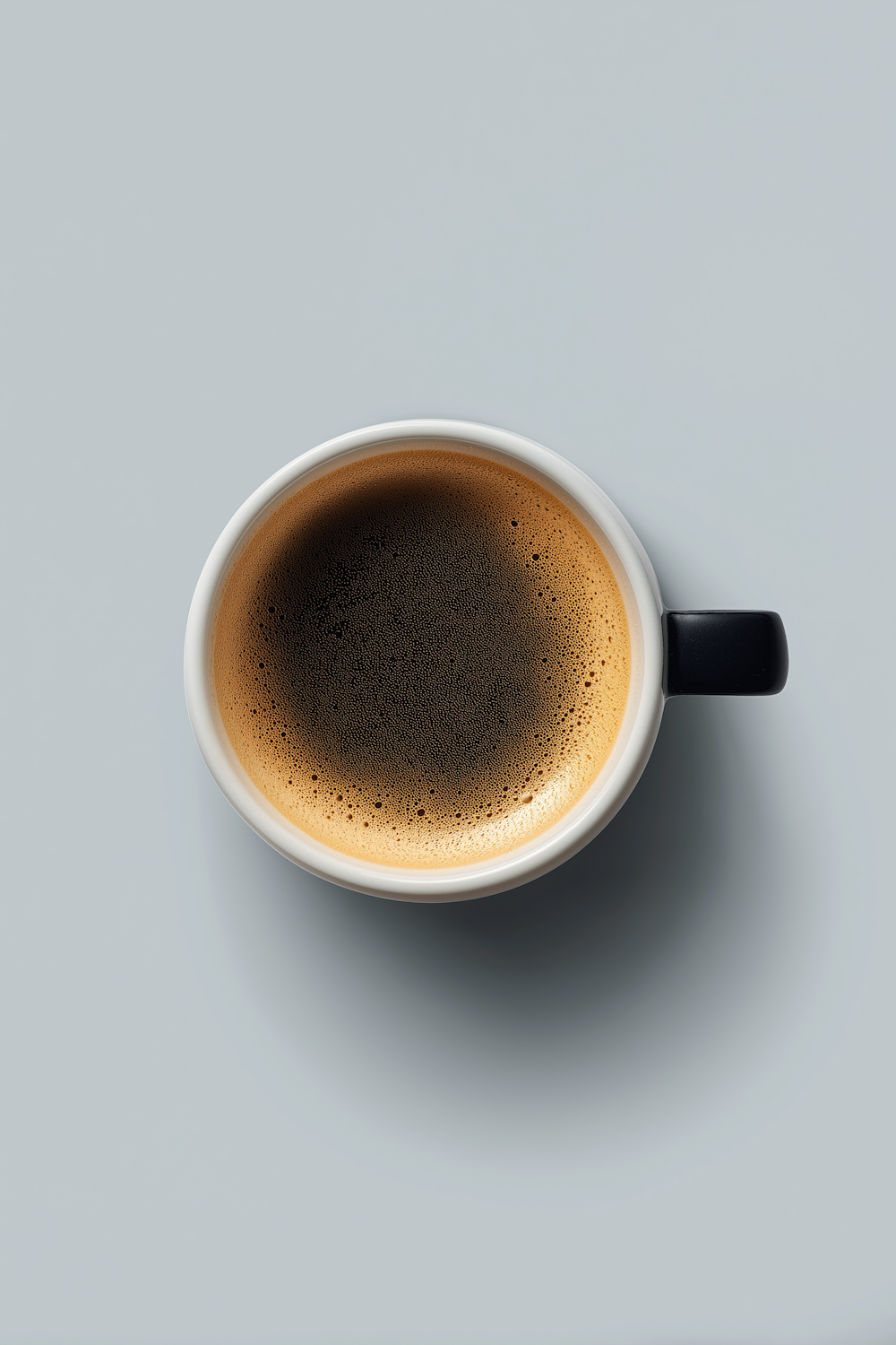 Top-down view of an espresso with rich crema in a white cup